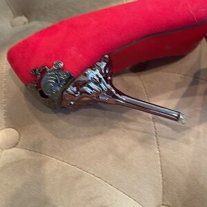 Red suede shoes with red bottoms